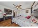 Comfortable main bedroom featuring warm wood floors and a ceiling fan at 6409 Dundock Ave, Las Vegas, NV 89122
