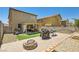 Large backyard with patio, artificial grass, BBQ grill, and fire pit, ideal for outdoor enjoyment at 6424 Strongbow Dr, Las Vegas, NV 89156
