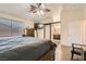 View of a bedroom with a hardwood floor, ceiling fan and en suite bathroom at 6424 Strongbow Dr, Las Vegas, NV 89156