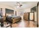 Spacious bedroom with a wooden bed frame, hardwood floors, and a ceiling fan at 6424 Strongbow Dr, Las Vegas, NV 89156