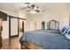 The primary bedroom is spacious with a hardwood floor, ceiling fan and en suite bathroom at 6424 Strongbow Dr, Las Vegas, NV 89156