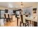 The dining area is adjacent to the kitchen, with modern table and chairs, and hardwood floors at 6424 Strongbow Dr, Las Vegas, NV 89156
