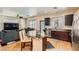 Open kitchen with stainless steel appliances, an island with seating, and hardwood floors at 6424 Strongbow Dr, Las Vegas, NV 89156