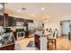 Modern kitchen with stainless steel appliances, a center island, and dark wood cabinets at 6424 Strongbow Dr, Las Vegas, NV 89156