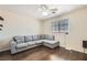 Relaxing living room showcases a gray sectional sofa, wood floors, and a bright window at 6424 Strongbow Dr, Las Vegas, NV 89156