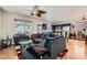 Open-concept living room and kitchen area with hardwood floors and modern furnishings at 6424 Strongbow Dr, Las Vegas, NV 89156