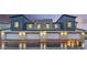 Modern townhome exterior featuring individual garages, stylish lighting, and contemporary gray and white color scheme at 6918 Wrightshire St # 24, Las Vegas, NV 89166