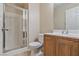 Clean bathroom featuring a glass-enclosed shower, toilet, and a vanity with a double sink at 7363 San Pablin St, Las Vegas, NV 89139