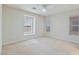 This carpeted bedroom has neutral walls, fan, and several windows allowing for natural light at 7363 San Pablin St, Las Vegas, NV 89139