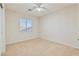 Neutral bedroom with fan, carpeted floor, and window allowing natural light at 7363 San Pablin St, Las Vegas, NV 89139
