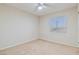 This carpeted bedroom has neutral walls, fan, and a window allowing for natural light at 7363 San Pablin St, Las Vegas, NV 89139