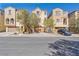 Inviting exterior of townhomes featuring desert landscaping and attached garages at 7363 San Pablin St, Las Vegas, NV 89139