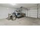 Spacious garage with an old car, a white door, and bright lighting at 7363 San Pablin St, Las Vegas, NV 89139