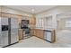 Kitchen featuring stainless steel appliances, tile flooring, and wood cabinets at 7363 San Pablin St, Las Vegas, NV 89139