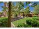 Picturesque backyard features covered patio, lush lawn, and mature trees for shade at 7486 Benlomond Ave, Las Vegas, NV 89179