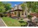Charming backyard features a covered patio, grassy area, and lush landscaping at 7486 Benlomond Ave, Las Vegas, NV 89179