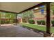 A relaxing backyard space with a covered patio, grassy area, and manicured shrubs at 7486 Benlomond Ave, Las Vegas, NV 89179