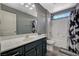 Bathroom featuring vanity, shower over tub and decorative shower curtain at 7486 Benlomond Ave, Las Vegas, NV 89179