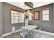 Modern dining room with unique light fixture, stylish chairs, and bright, airy feel at 7486 Benlomond Ave, Las Vegas, NV 89179