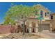 Inviting home exterior with landscaped front yard, featuring a lovely tree and neutral-colored facade at 7486 Benlomond Ave, Las Vegas, NV 89179