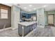 Well-lit kitchen with a center island, stainless steel appliances, and stylish backsplash at 7486 Benlomond Ave, Las Vegas, NV 89179
