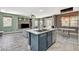 Open concept kitchen with island, stainless steel sink, and view to living room at 7486 Benlomond Ave, Las Vegas, NV 89179