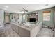 Open living space with a large sectional, custom wall decor, and plenty of natural light at 7486 Benlomond Ave, Las Vegas, NV 89179