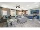 Spacious living room with a modern couch, glass table, and open access to the kitchen area at 7486 Benlomond Ave, Las Vegas, NV 89179