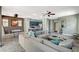 Large living area with seamless transition to dining, featuring ample seating and neutral tones at 7486 Benlomond Ave, Las Vegas, NV 89179