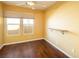 Bedroom with hardwood floors, natural light, and a simple wall-mounted shelf at 7491 Speedwell Cavern St, Las Vegas, NV 89139