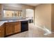 Well-lit kitchen with stainless steel sink, black dishwasher, and a view of the breakfast nook at 7491 Speedwell Cavern St, Las Vegas, NV 89139