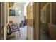 A cozy patio setting includes chairs and a trashcan on light colored paving at 7491 Speedwell Cavern St, Las Vegas, NV 89139
