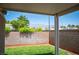 View of backyard with covered patio, brick wall and lush green landscaping at 7500 Peaceful Brook St, Las Vegas, NV 89131