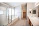 Bathroom featuring a glass door shower, separate bathtub and a double sink vanity at 7500 Peaceful Brook St, Las Vegas, NV 89131