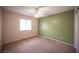 Bedroom with carpeted floors, a ceiling fan, and a window for natural light at 7500 Peaceful Brook St, Las Vegas, NV 89131