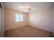 Bedroom with carpeted floors, a ceiling fan, and a window for natural light at 7500 Peaceful Brook St, Las Vegas, NV 89131