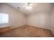 Bedroom with carpeted floors, a ceiling fan, and a window for natural light at 7500 Peaceful Brook St, Las Vegas, NV 89131