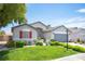 Attractive home with a green lawn, colorful flowers, and a neatly landscaped yard at 7500 Peaceful Brook St, Las Vegas, NV 89131