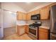 Spacious kitchen with stainless steel appliances and wood cabinets at 7500 Peaceful Brook St, Las Vegas, NV 89131