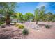 Beautiful landscaping with palm trees, river rock, and colorful plants enhancing the property at 7500 Peaceful Brook St, Las Vegas, NV 89131