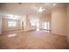 Expansive living area featuring ceiling fans, carpet and wood flooring, and an open floor plan at 7500 Peaceful Brook St, Las Vegas, NV 89131
