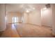 Spacious living room featuring plush carpeting and french doors leading to the backyard at 7500 Peaceful Brook St, Las Vegas, NV 89131