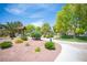 Charming park feature with stone accents, greenery, and a paved pathway at 7500 Peaceful Brook St, Las Vegas, NV 89131