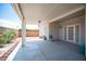 Covered patio featuring a neutral color scheme, brick border and beautiful landscaping at 7500 Peaceful Brook St, Las Vegas, NV 89131