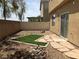 Backyard with a rock garden, artificial turf, and a stone paver walkway at 7788 Soda Canyon St, Las Vegas, NV 89139