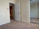 Carpeted bedroom with a sliding door closet and a view into an ensuite bathroom at 7788 Soda Canyon St, Las Vegas, NV 89139