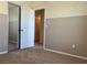 Carpeted bedroom with a sliding door closet and a view into an additional room at 7788 Soda Canyon St, Las Vegas, NV 89139