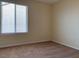 Bedroom with carpeted floor, neutral-colored walls and a window at 7788 Soda Canyon St, Las Vegas, NV 89139