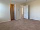 View of a bedroom with two doors and neutral carpet and paint at 7788 Soda Canyon St, Las Vegas, NV 89139