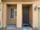 Front porch with tan columns and matching trim and a dark colored front door at 7788 Soda Canyon St, Las Vegas, NV 89139
